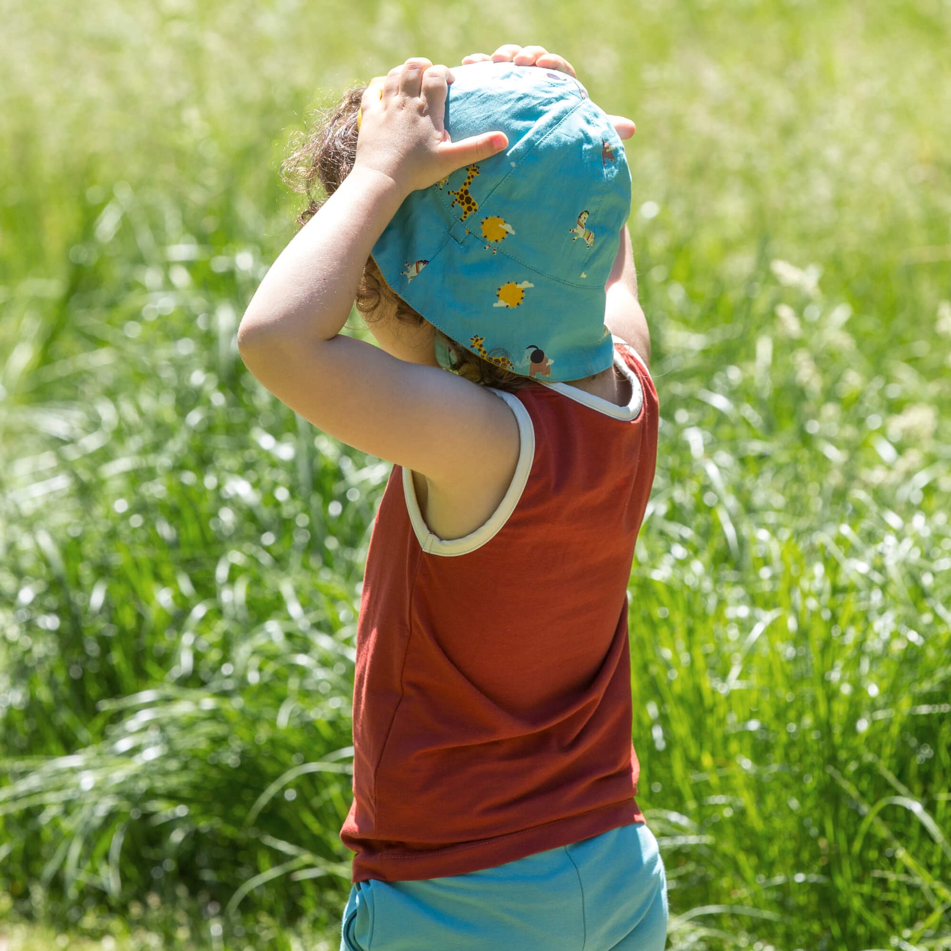 Little-Green-Radicals-Blue-Reversible-Sunhat-With-Giraffe-Horse-Elephant-Print-Kid-Back