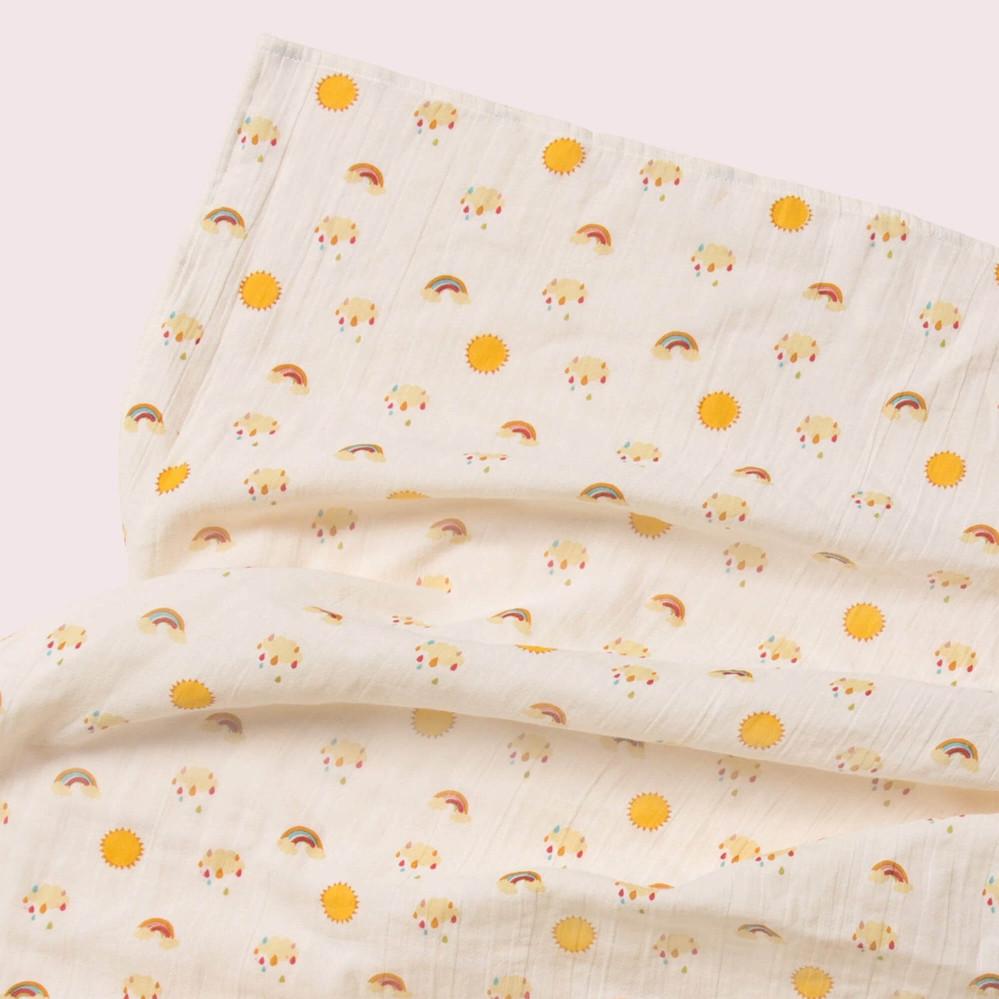 Little-Green-Radicals-Cream-And-Orange-Organic-Baby-Muslin-Set-2-Pack-With-Sunshine-and-Rainbow-Print-Closeup