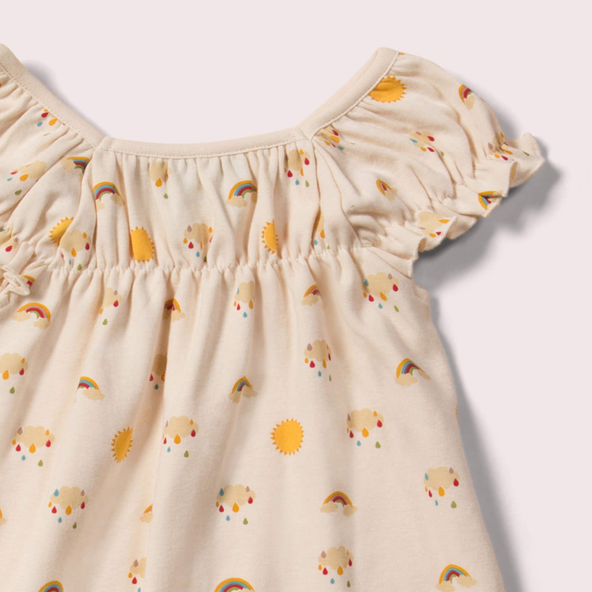 Little-Green-Radicals-Cream-Pocket-Playdays-Dress-With-Sunshine-And-Rainbow-Print-Closeup