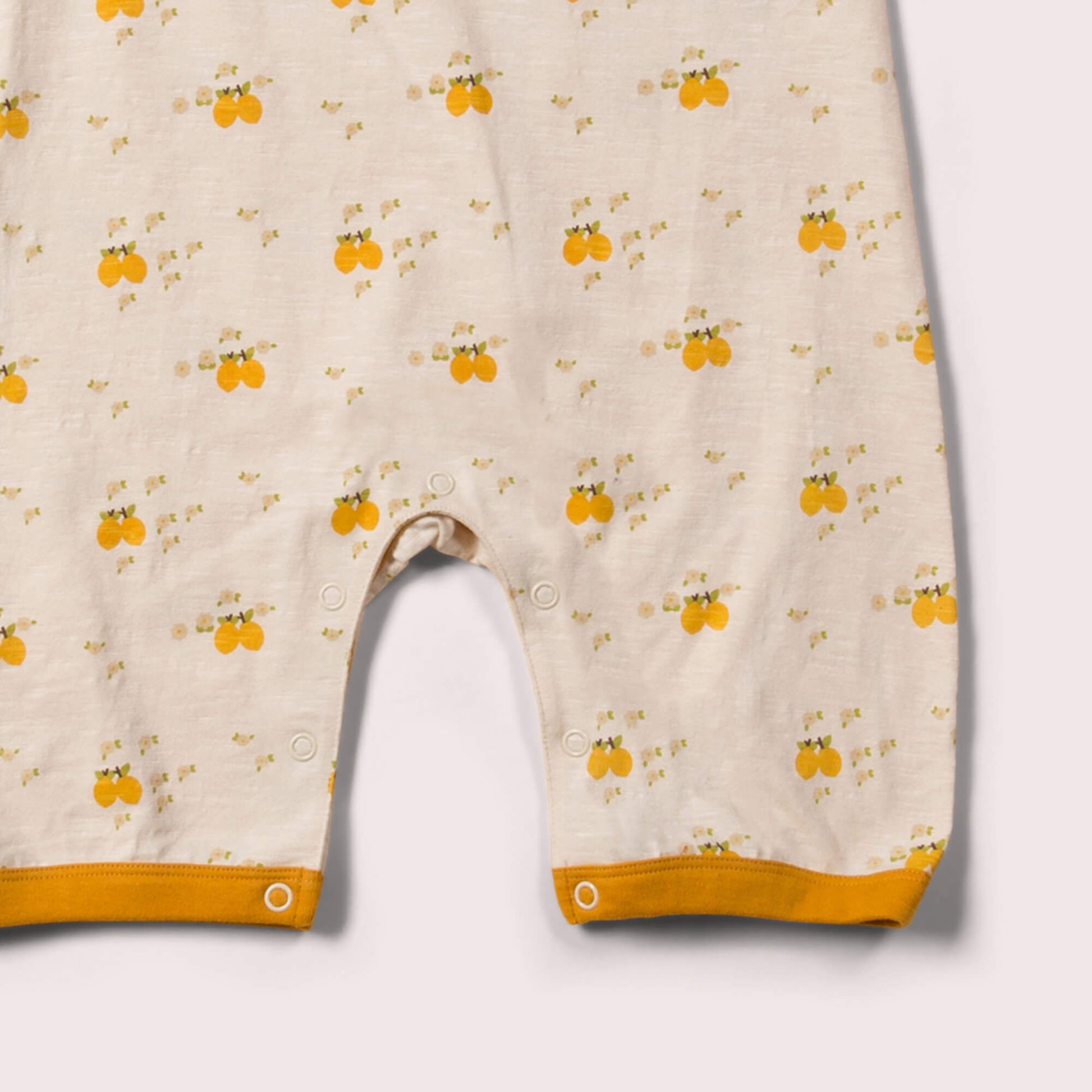 Little-Green-Radicals_Cream-and-Yellow-Organic-Shortie-Romper-With-Lemon-Grove-Print-Kid-Posing