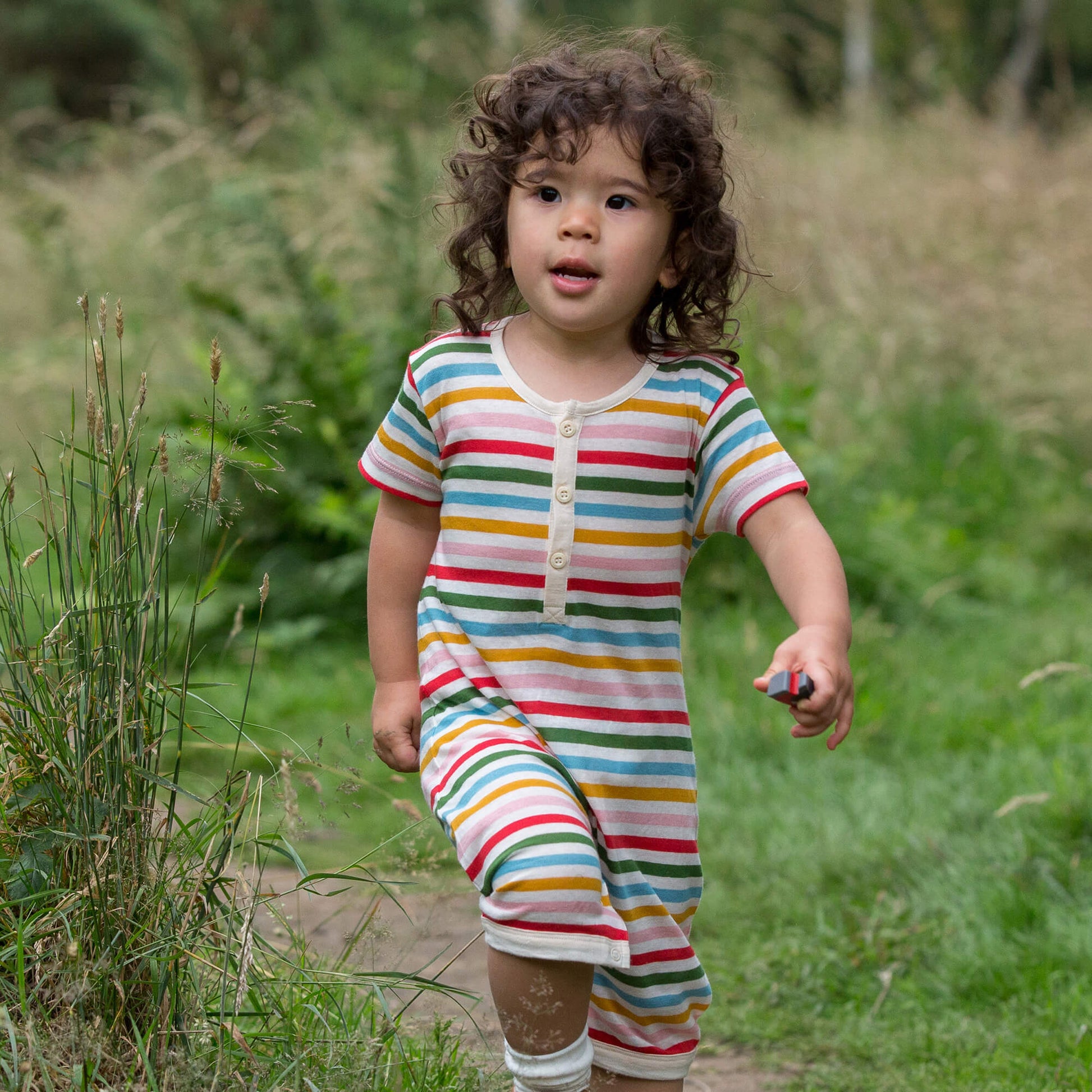 Little-Green-Radicals_Red-Green-Blue-Orange_Pink-and-Cream-Striped-Organic-Shortie-Romper-With-Rainbow-Print-Kid
