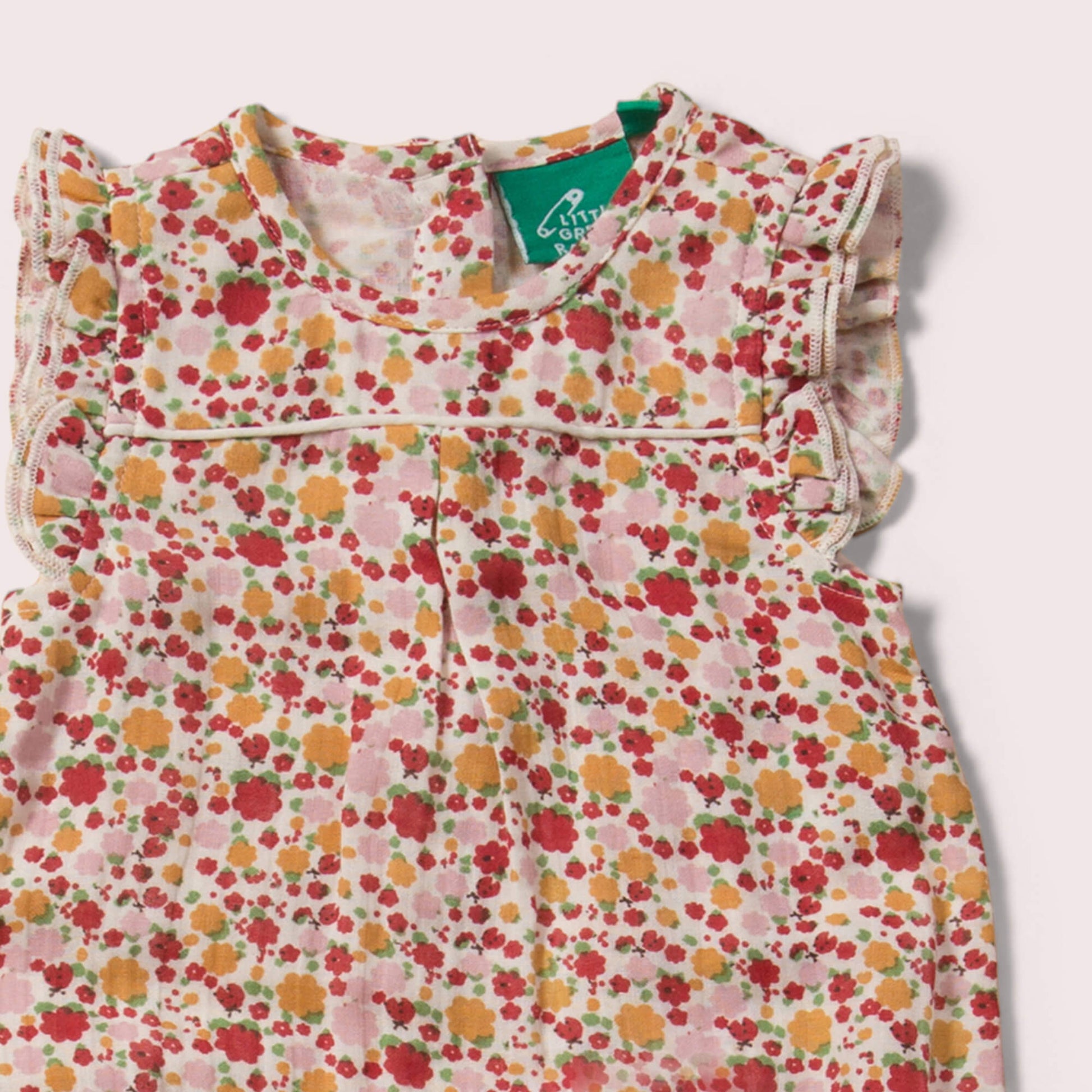Little-Green-Radicals_Red-Yellow-Pink-And_Cream-Organic-Summer-Romper-With-Ladybird-Pattern-Closeup