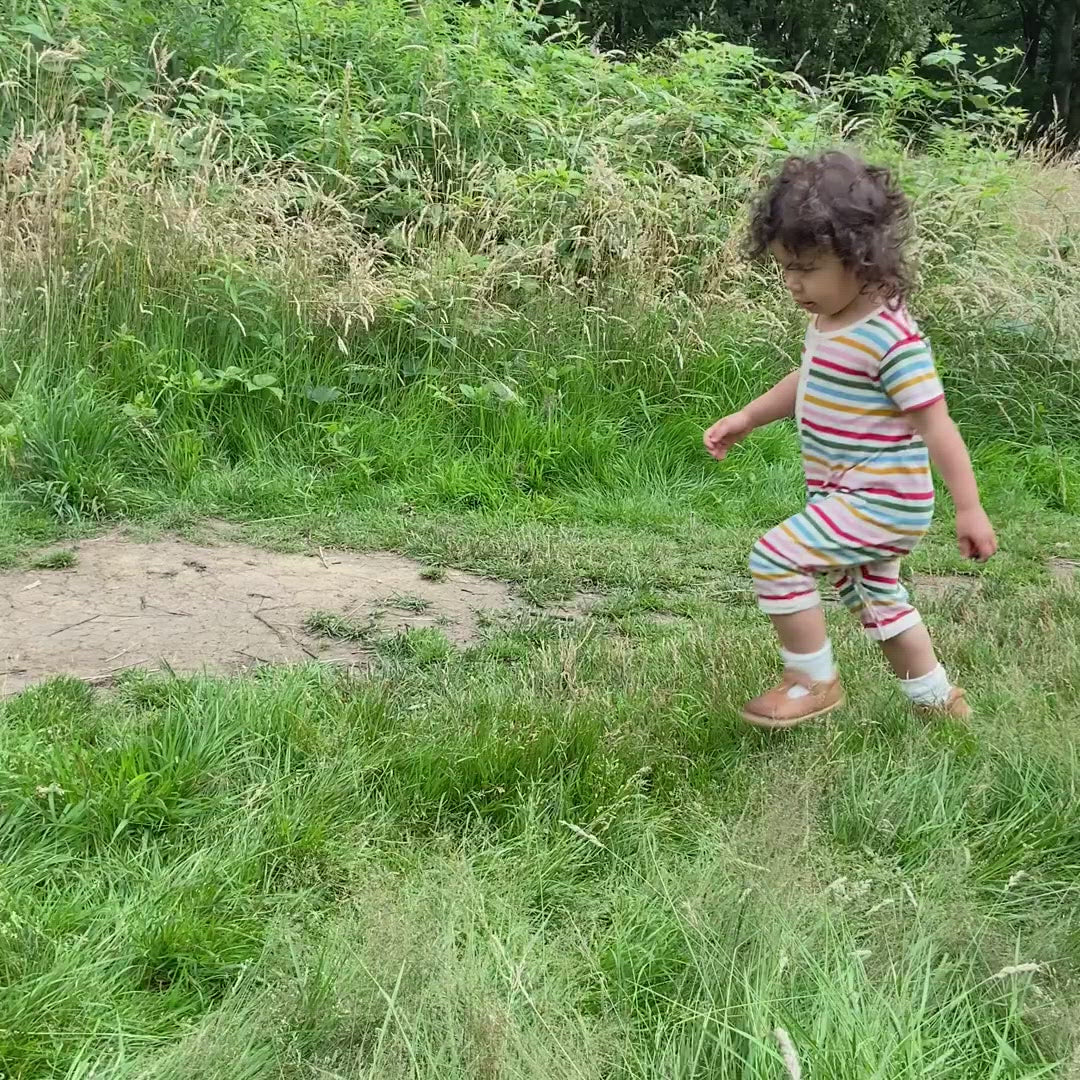 Little-Green-Radicals—Red-Green-Blue-Orange—Pink-and-Cream-Striped-Organic-Shortie-Romper-With-Rainbow-Print-Video